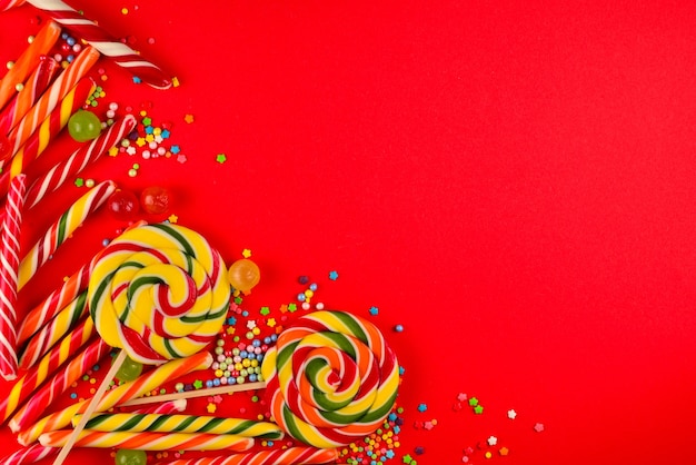 Colorful candies on a red  background