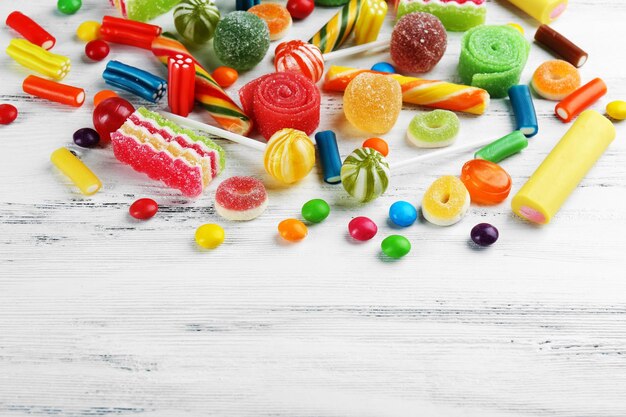 Colorful candies on wooden background