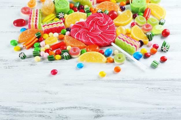 Colorful candies on wooden background