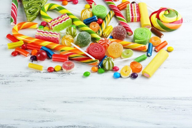 Colorful candies on wooden background