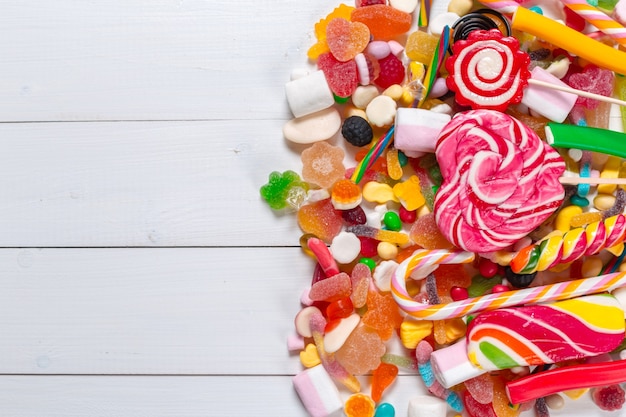 Colorful candies on wooden background