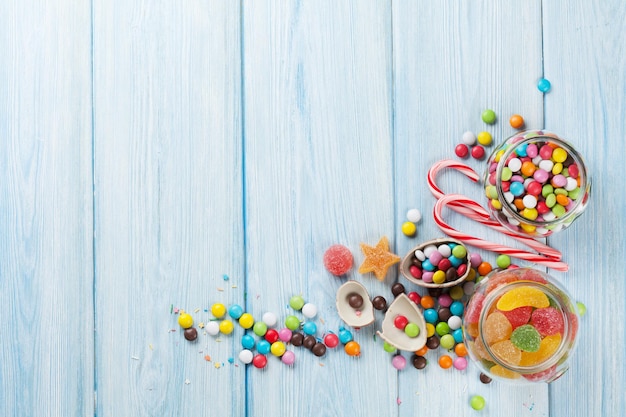 Colorful candies on wooden table