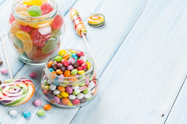 Colorful candies on wooden table