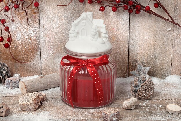 Colorful candle and colored candles of various shapes with a Christmas background on a wooden backgr