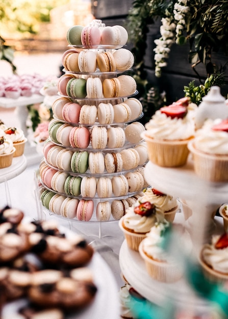 Colorful candy bar with sweets and pastry on wooden stands