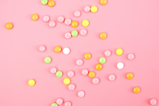 Colorful candy on pink background