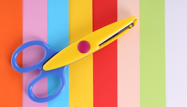 Colorful cardboard and scissors closeup