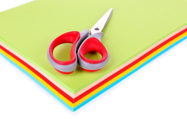 Colorful cardboard and scissors on white background