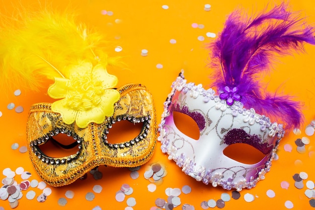 Colorful carnival masks on an orange background