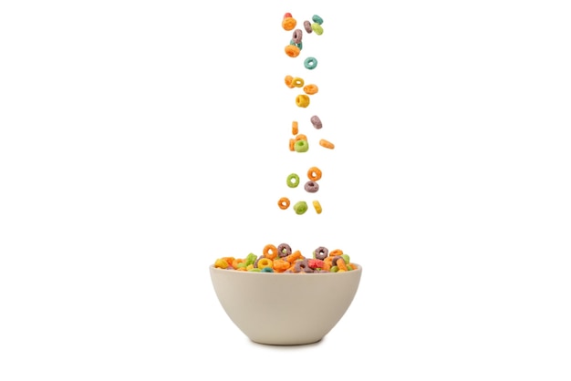 Colorful cereal box for morning breakfast Corn flakes falling to the white bowl Motion Copyspace