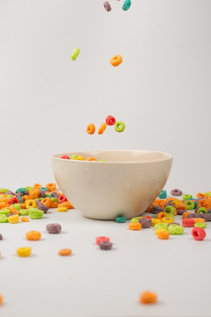 Colorful cereal box for morning breakfast Corn flakes falling to the white bowl Motion