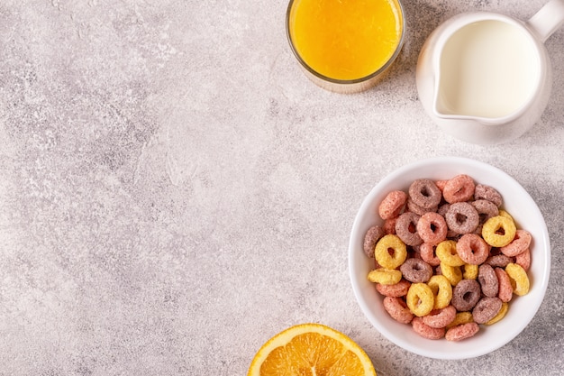 Colorful cereal rings in bowl and milk