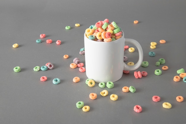 Photo colorful cereals in mug mockup