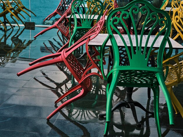 Colorful chairs in the garden after the rain