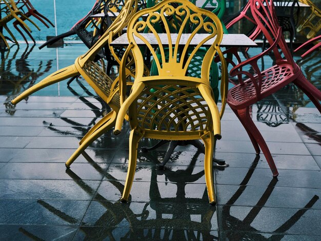 Colorful chairs in the garden after the rain