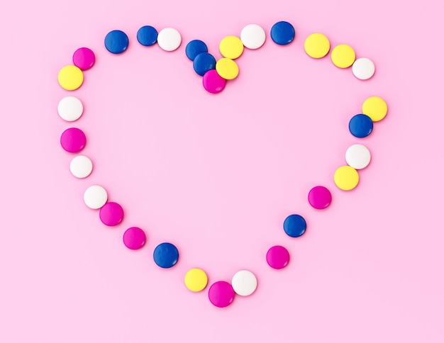 Colorful chocolate button candy coated beans Heart shaped on pink valentine anniversary love