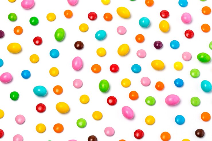 Colorful chocolate candy pills isolated on white background