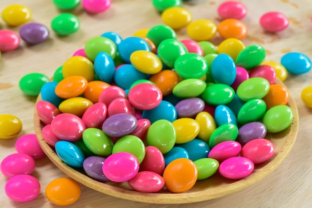 Colorful chocolate candy in wooden container