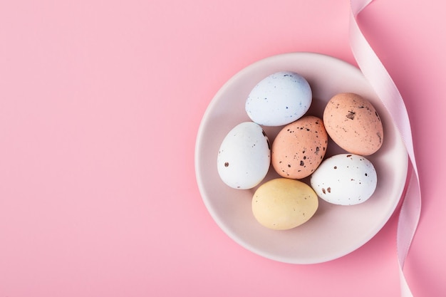 Colorful chocolate easter eggs Sweet candy eggs on a pink background Top view