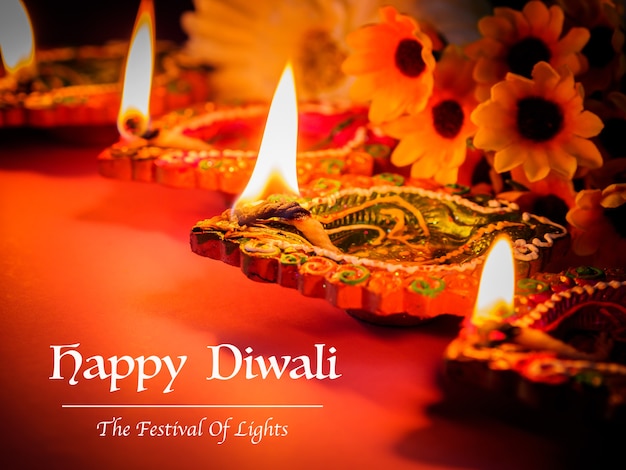 Colorful clay diya lamps lit with flowers for the Hindu Diwali festival. 