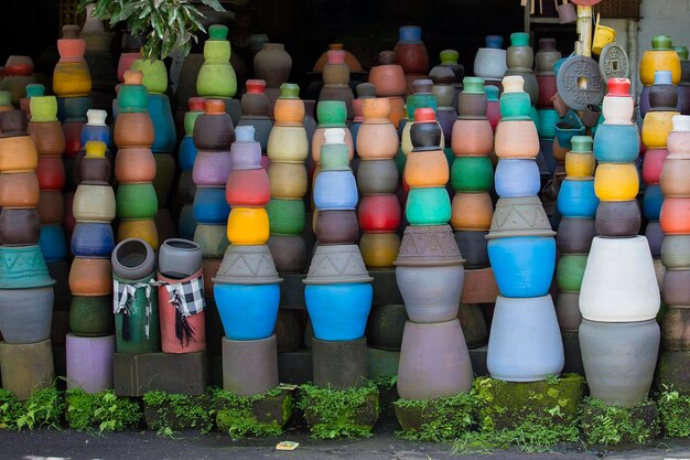 Colorful clay pots on the ground Tourist art and craft market Bali Island Indonesia Close up