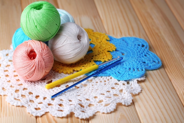 Colorful clews napkin and crochet hooks on wooden background