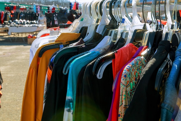 Colorful clothes fashion hang on a shelf at flea market shopping in town