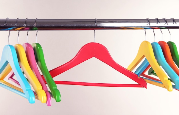 Colorful clothes hangers on gray background