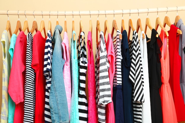 Colorful clothes on hangers in room