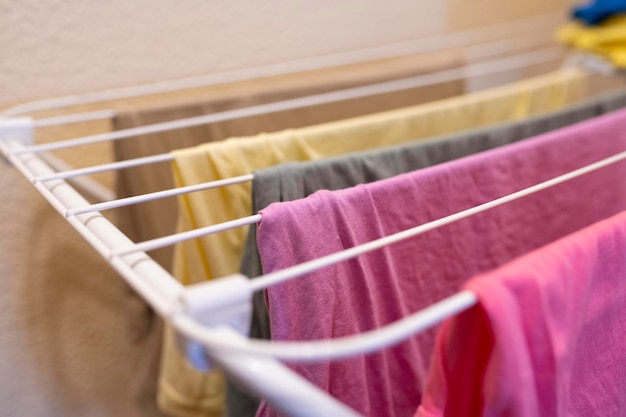 Colorful clothes hanging indoors on an interioir clothesline