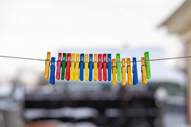 Colorful clothespins on a clothesline with the word " on the front. "