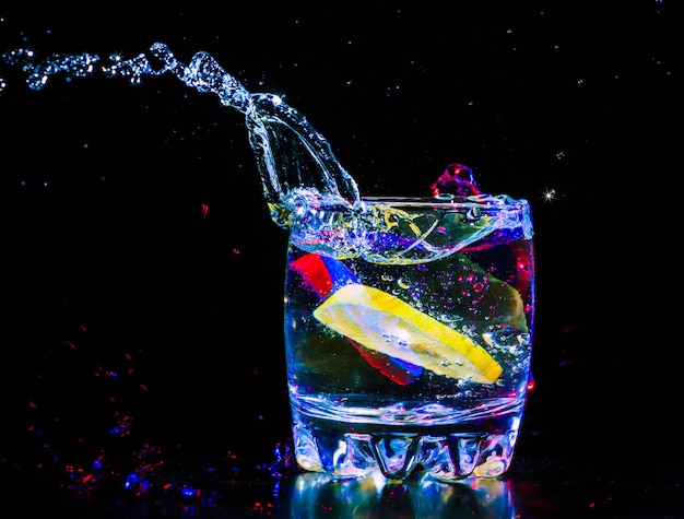 Colorful cocktail splashing from a glass