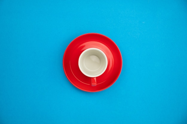 Colorful coffee cup on blue paper background