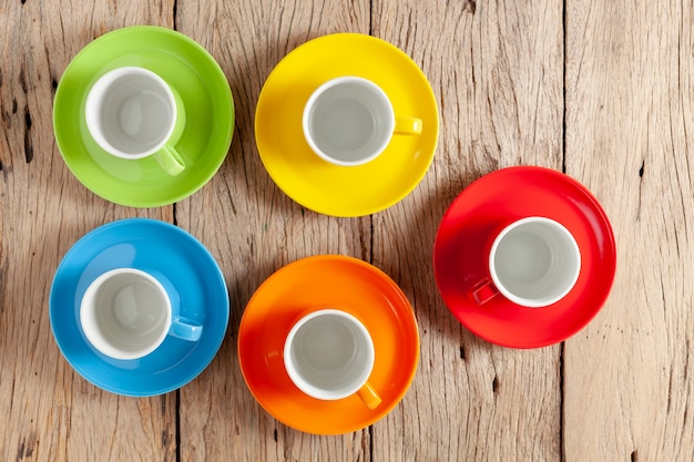 Colorful coffee cup on old wooden background