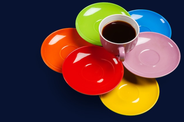 Colorful coffee cups and saucers on colorful vibrant