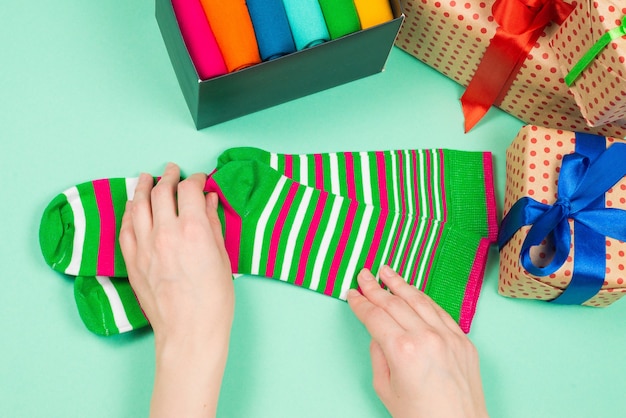 Colorful collection of cotton socks as a gift in woman hands. Gift.