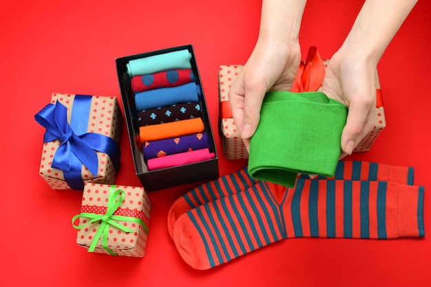 Colorful collection of cotton socks as a gift in woman hands