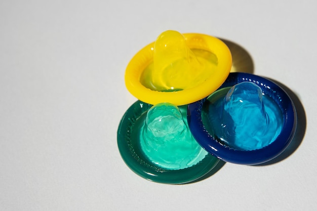 Colorful condoms on a light background