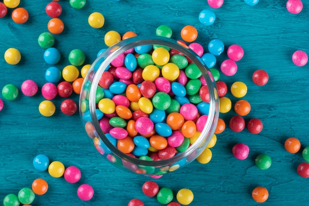 Colorful Confetti candy in bowl with blue background.