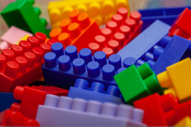 A colorful constructor set, which lies on the floor of a house, close-up. Educational games for children. plastic children's designer cubes, selective focus .