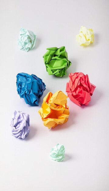 Colorful crumpled paper ball on white background generative ai