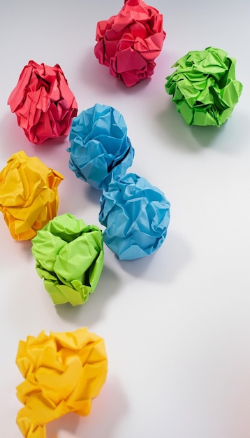 Colorful crumpled paper ball on white background generative ai