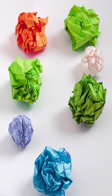 Colorful crumpled paper ball on white background generative ai