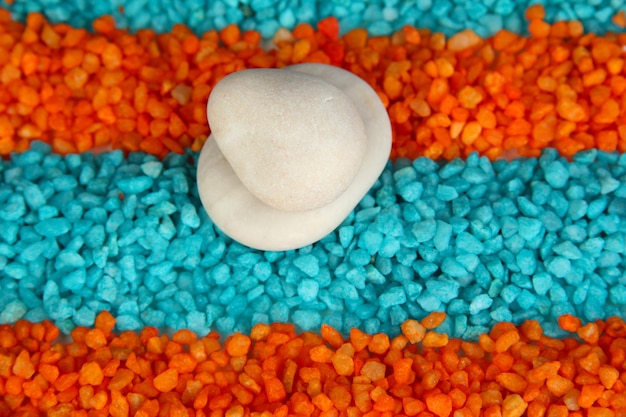 Colorful crystals of sea salt with white stones close up