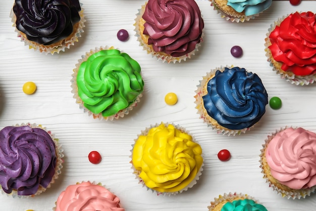 Colorful cupcakes on white wooden