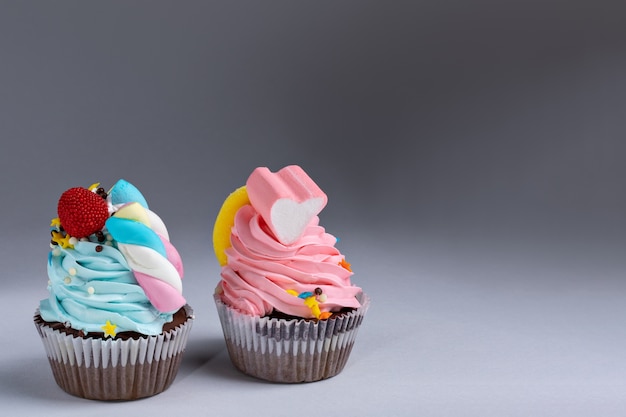 Colorful cupcakes with marshmallows on top