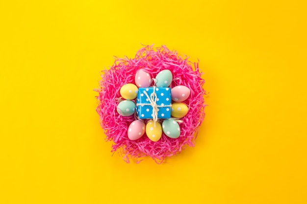 Colorful decorated Easter eggs on a bright yellow background