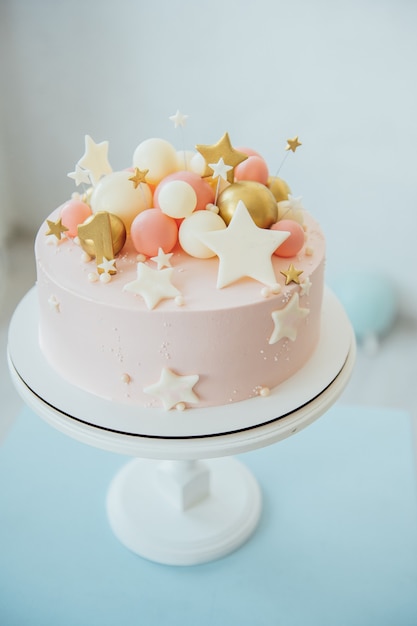 Colorful decoration of a first year birthday cake.