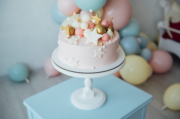 Colorful decoration of a first year birthday cake.