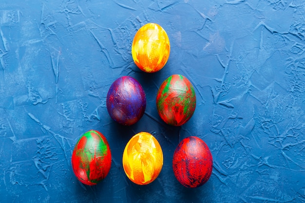 Colorful decorative eggs on a blue background